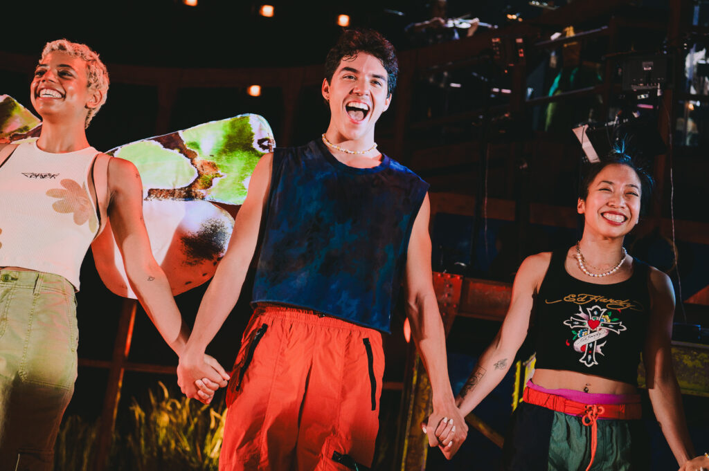 Alejandro Vargas holding hands with other performers on stage