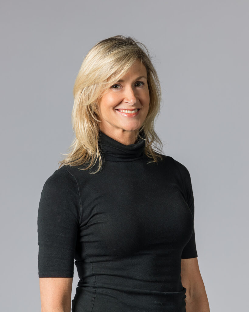 Teresa Chapman's headshot. She is blonde and wearing a black turtleneck.