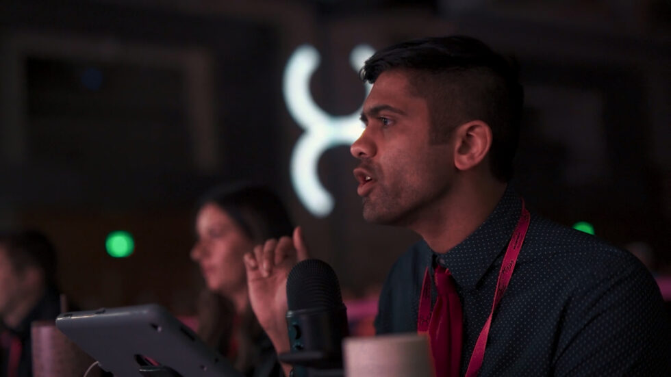 A male judge speaking into a microphone.